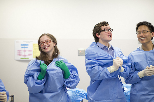 Three people in hospital scrubs.