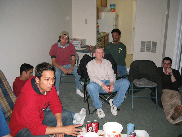 Six young men hanging out at someone's house.
