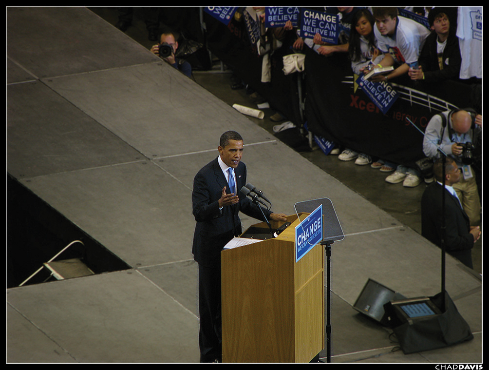 President Barack Obama speaking at a podium with two teleprompters in front of him.