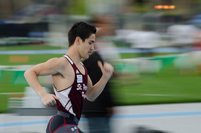 A track athlete running in a race.