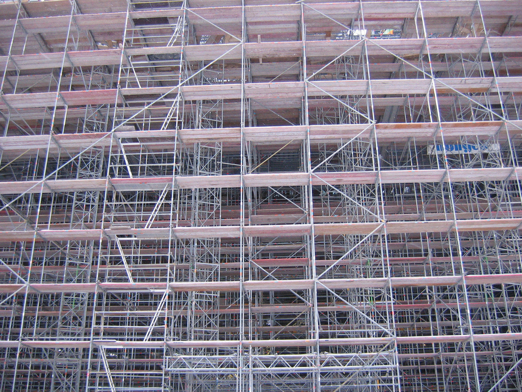 Construction scaffolding on the side of a multi-story building.