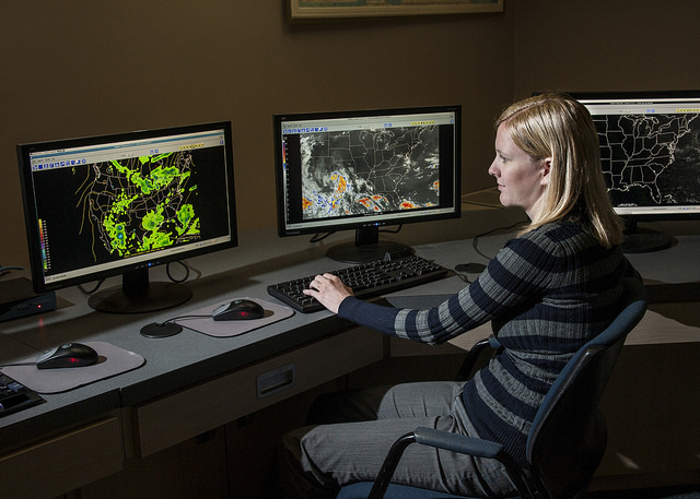 A young woman at a computer station.
