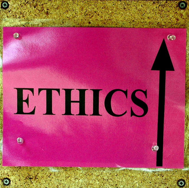 A sign with the word "ethics" and an arrow pointing up.