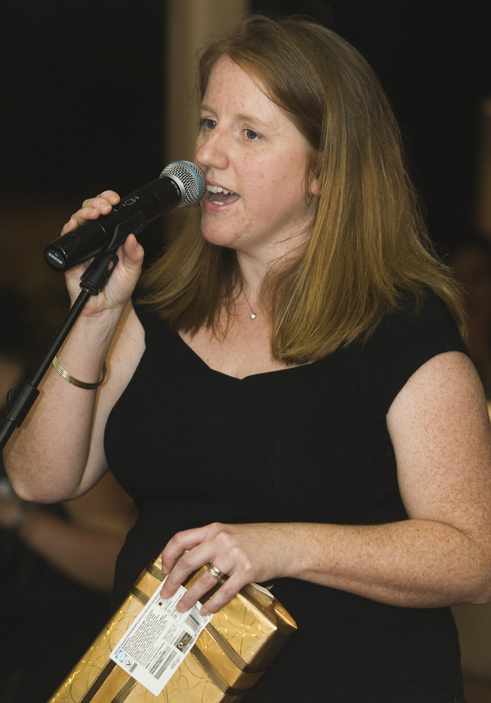 A woman speaking into a microphone.