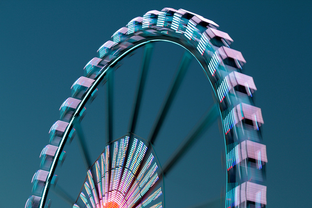 A blurry ferris wheel in motion.