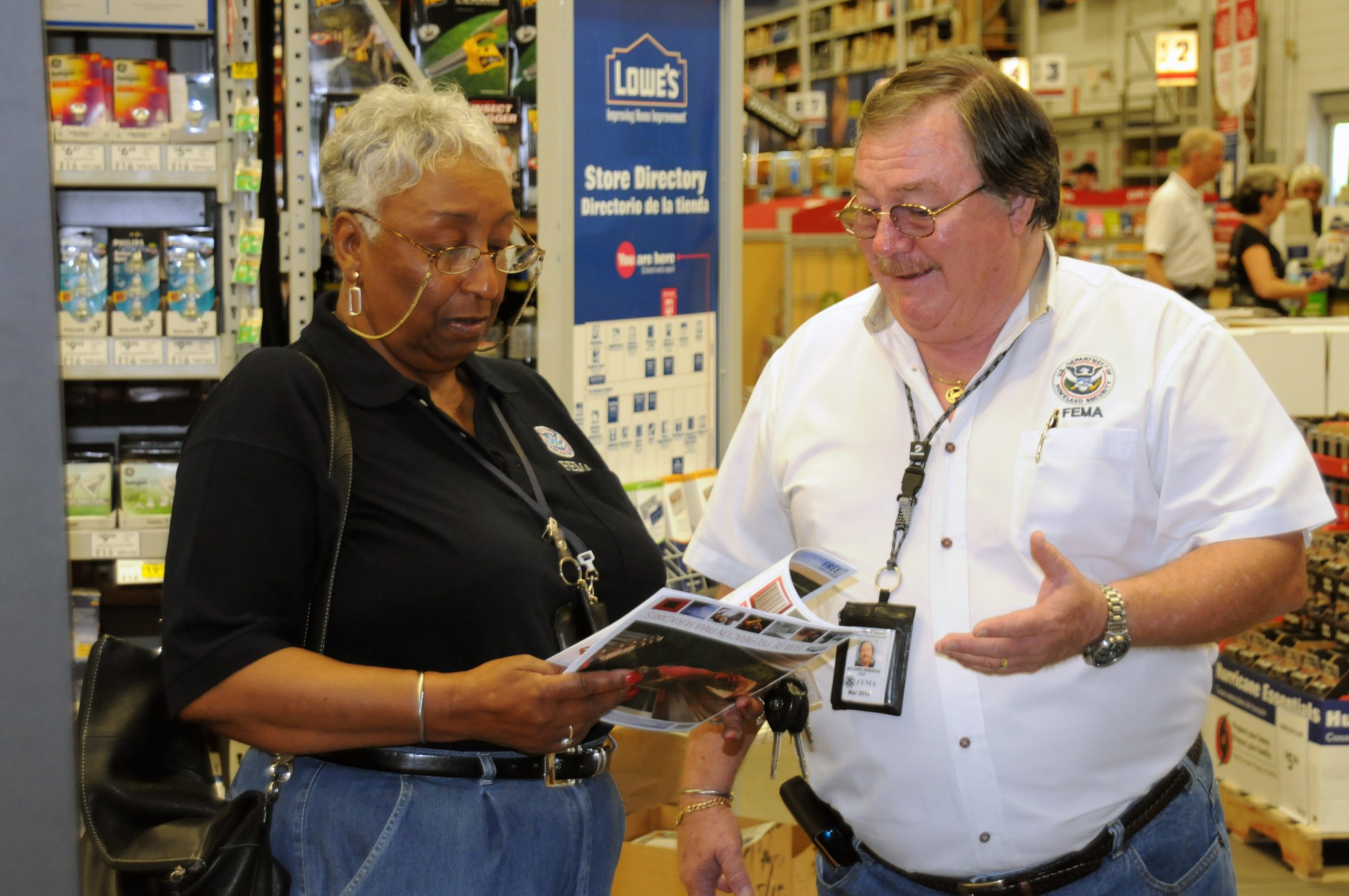 A supervisor and worker at Lowe's having a conversation.