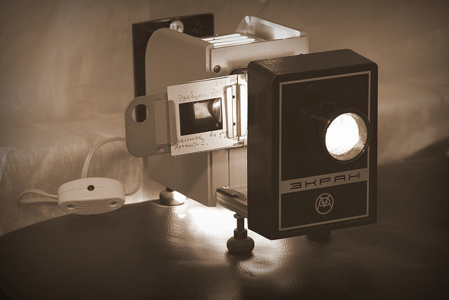 A slide projector with the light on.