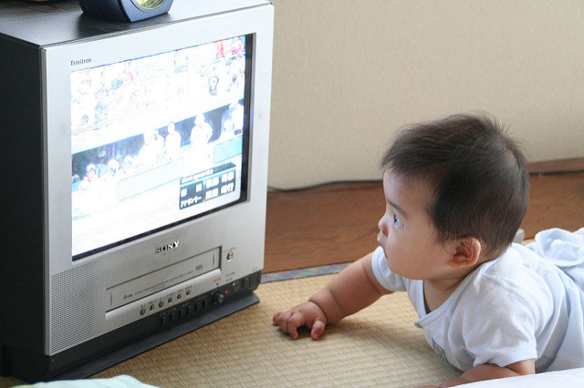 A baby watching television.