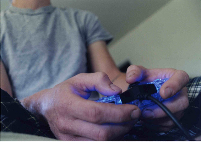 Hands on a game controller.