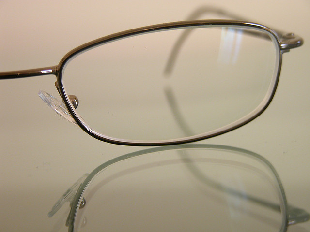 Close up of half of a pair of seeing glasses.