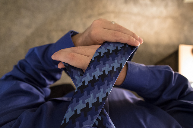 A man tying tie.