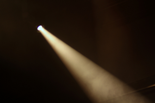 A spotlight shining into a dark space.