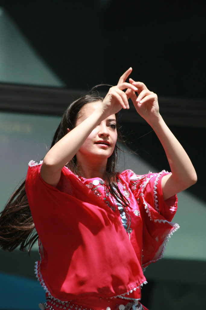 A young woman on stage signing.